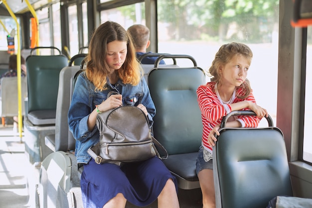 Passengers of a city bus sitting