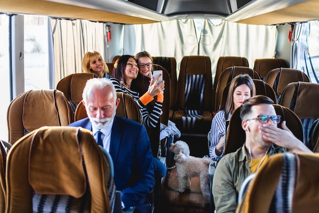 Photo passengers and dog traveling by bus.