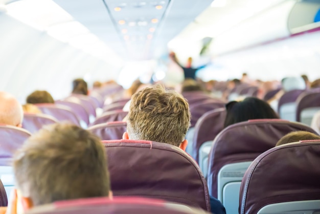 Passengers sit inside airplane - people traveling