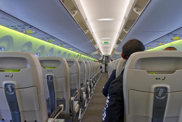 Passengers traveling by plane inside of an airplane