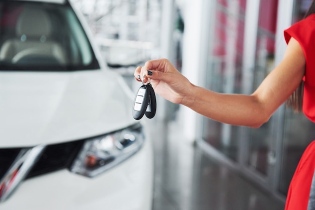 Passing car keys. Cropped closeup of a car dealer holding out car keys