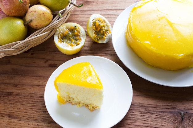 Passion fruit cake on white plate over wooden table