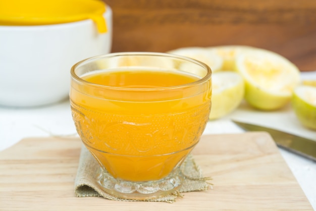 Passion fruit and juice in glass on wood table