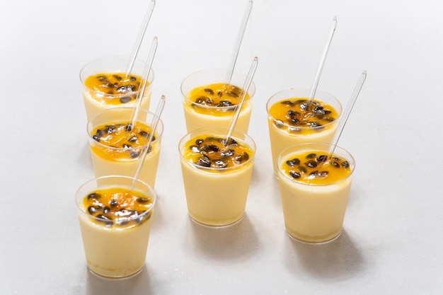 passion fruit mousse, small glass with passion fruit mouse on white background