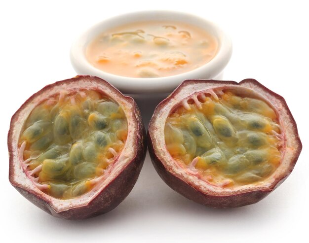 Passion fruit sliced with a bowl full of juice