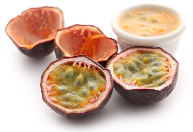 Passion fruit sliced with a bowl full of juice