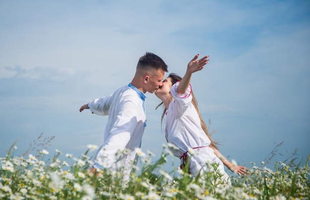 Passion pure love in chamomile field of kissing couple man and woman