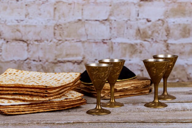 Passover background. wine and matzoh jewish holiday bread over wooden board.