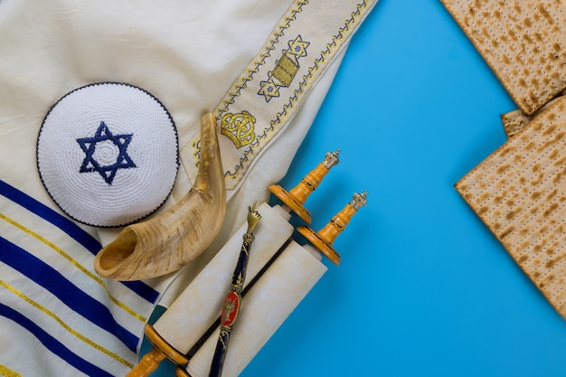 Passover day traditional celebration with kosher matzah unleavened bread on torah scroll of Jewish holiday Pesach