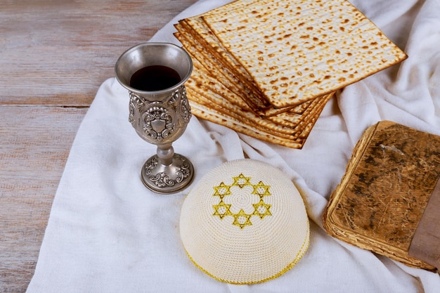 Passover holiday concept with wine and matzoh over rustic background