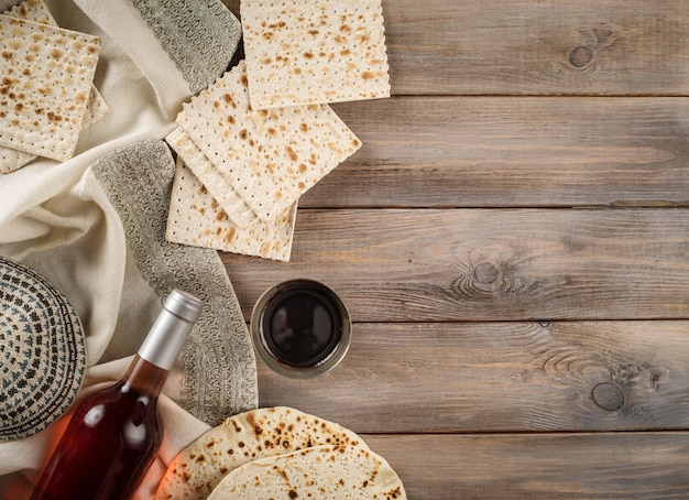 Passover holiday traditional celebration with cup wine kosher matzah unleavened bread on of Jewish Pesach. Flat lay.