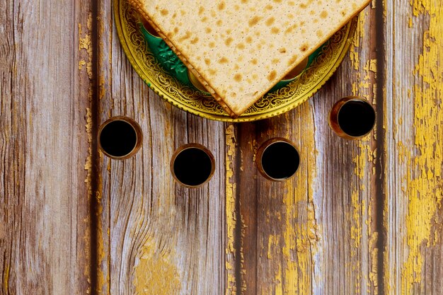 Passover wine and matzoh jewish holiday bread on wooden board