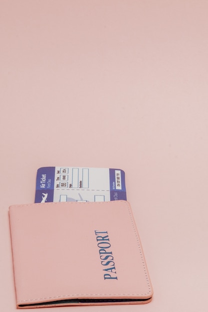 Passport and air ticket on a pink.