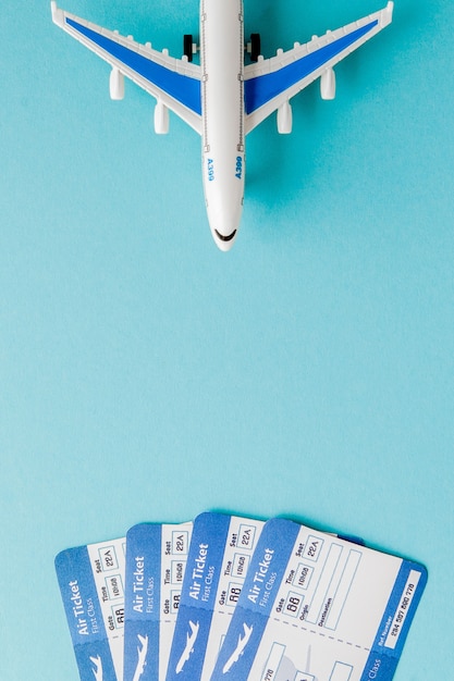 Photo passport, airplane and air ticket on blue