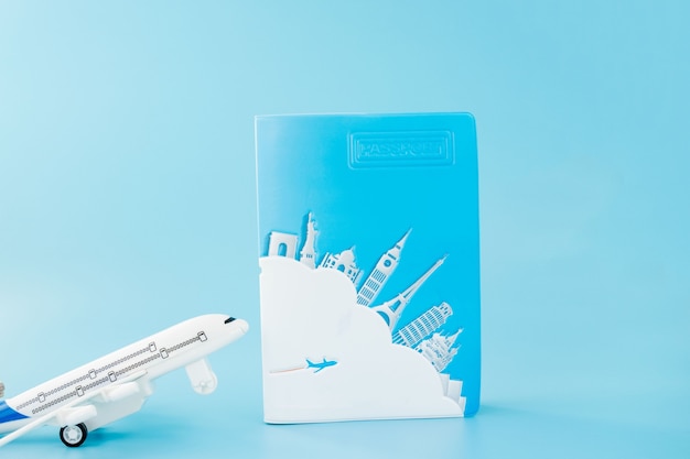 Passport and airplane on light blue background.Summer or vacation concept. Copy space.