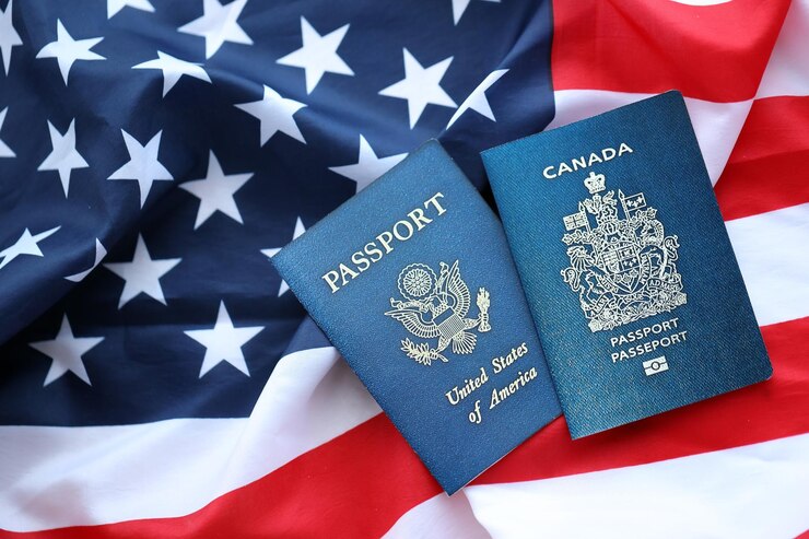 Photo passport of canada with us passport on united states of america folded flag close up