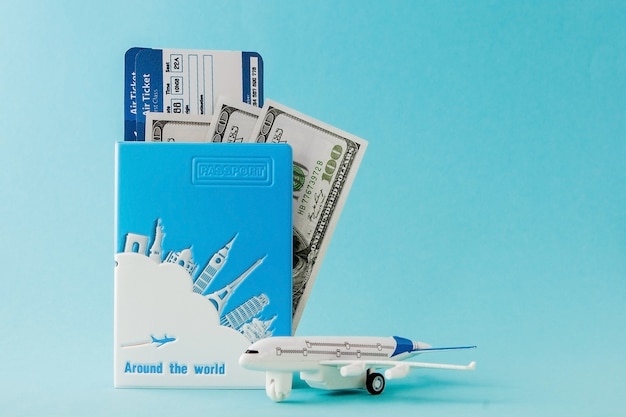 Passport dollars plane and air ticket on blue