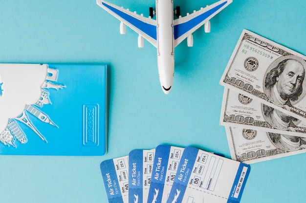 Passport dollars plane and air ticket on blue