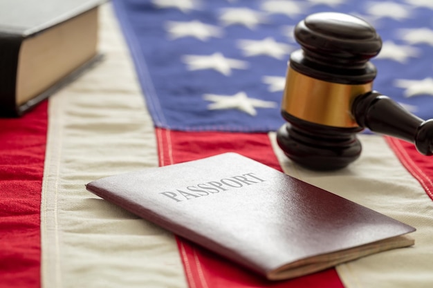 Passport and law gavel on USA flag background close up view