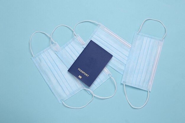 Passport and medical masks on a blue background