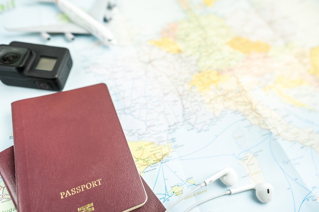 Photo passport with a map background.travel planning.top view of traveler accessories with a plane, camera on world map.