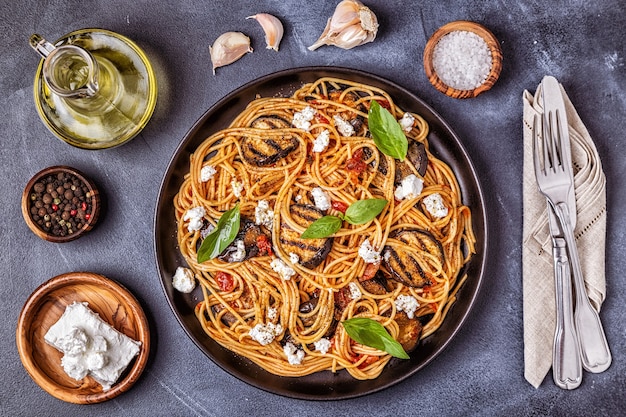 Pasta alla Norma - traditional Italian food with eggplant, tomato, cheese and basil