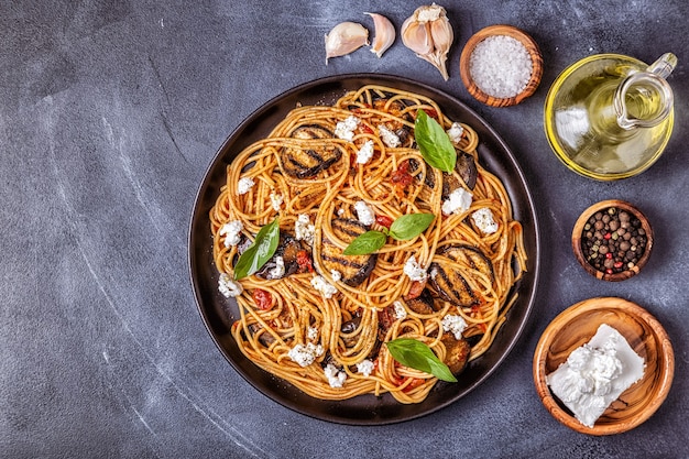 Pasta alla Norma - traditional Italian food with eggplant tomato cheese and basil