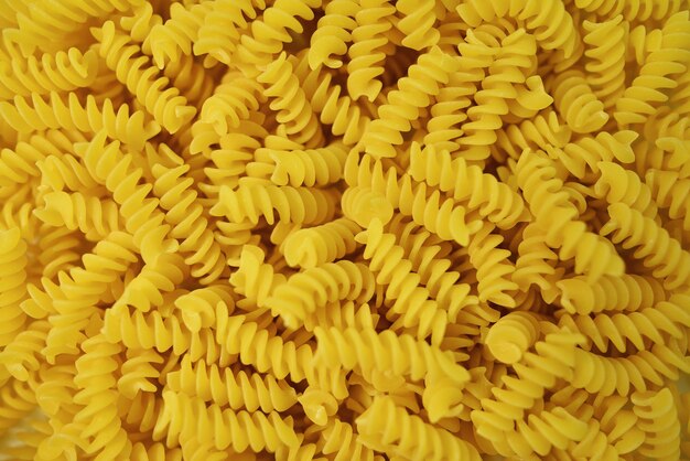 Pasta background. Dry pasta fusilli. Top view