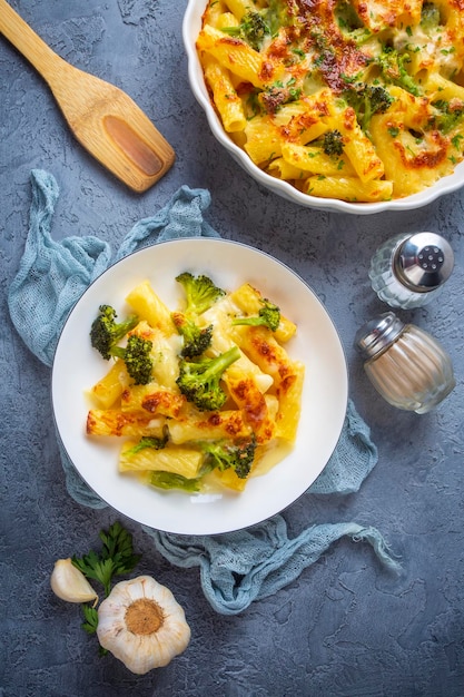 Pasta baked with broccoli and chicken. Broccoli, cheese and gratin sauce on baked penne pasta.