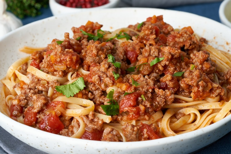 Photo ミンチ肉、トマト、パルメザンチーズのパスタボロネーゼリングイネ。