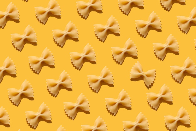 pasta bows on an orange background Cooking concept