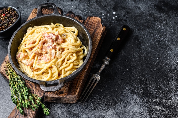 Pasta Carbonara with bacon and parmesan in a pan.   top view.