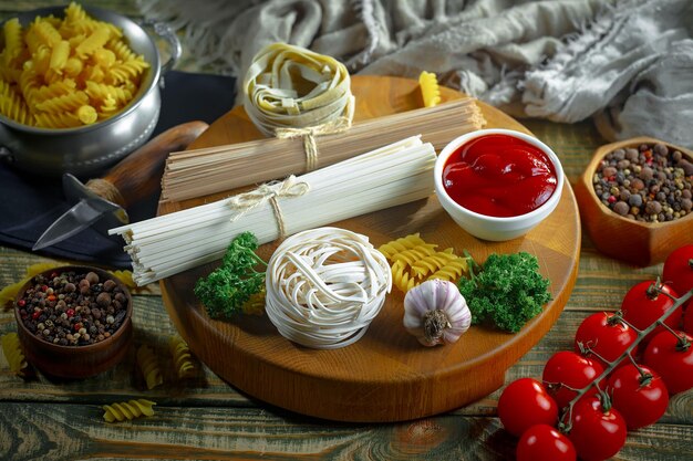 Pasta in composition with vegetables in the kitchen