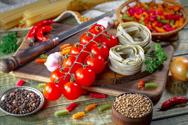 Pasta in composition with vegetables in the kitchen