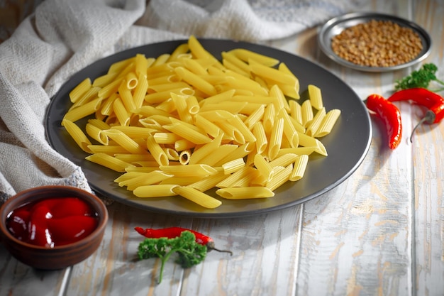 Pasta in composition with vegetables in the kitchen