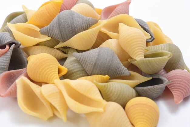 Pasta conchiglie on white background