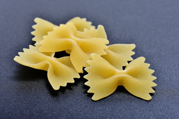 Pasta farfalle on black background