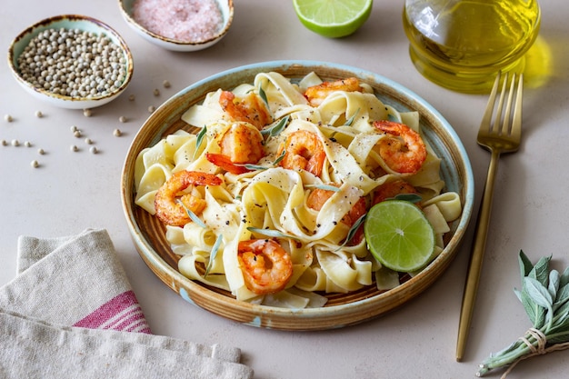 Pasta fettuccine in a creamy sauce with shrimp lime and sage Italian food