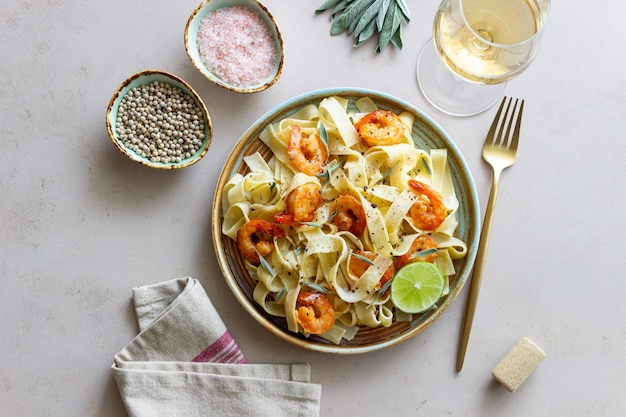 Pasta fettuccine in a creamy sauce with shrimp lime and sage Italian food