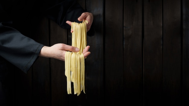 Pasta in hands. homemade pasta.