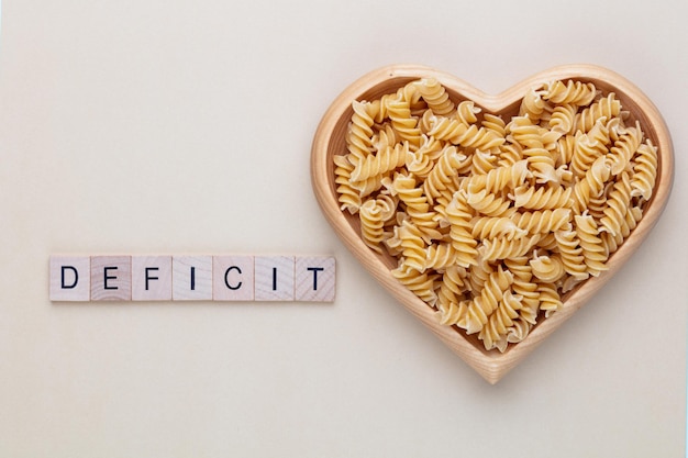 Pasta in a heart shaped wood bowl