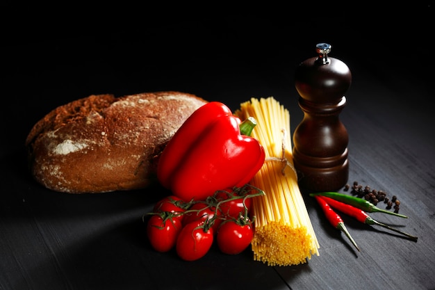 Pasta ingredients on black table