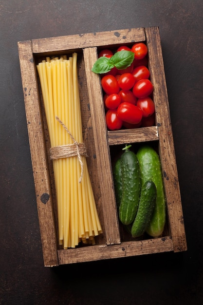 Pasta and ingredients Tomato basil cucumber Cooking concept Top view