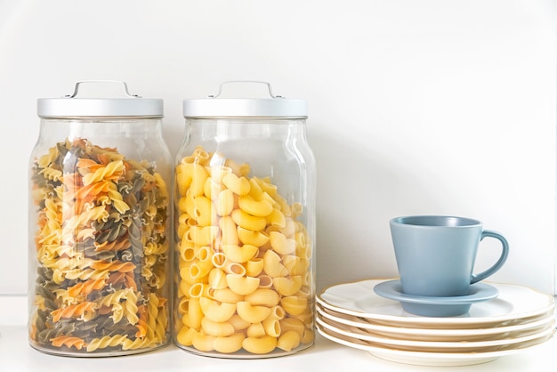 Pasta in a jar and coffee cup in kitchen