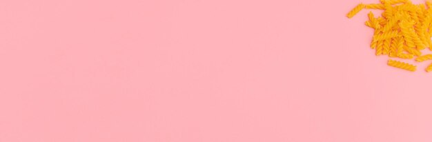 Photo pasta lying on a pink background banner