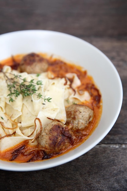 Pasta meatballs tomato sauce on wood background