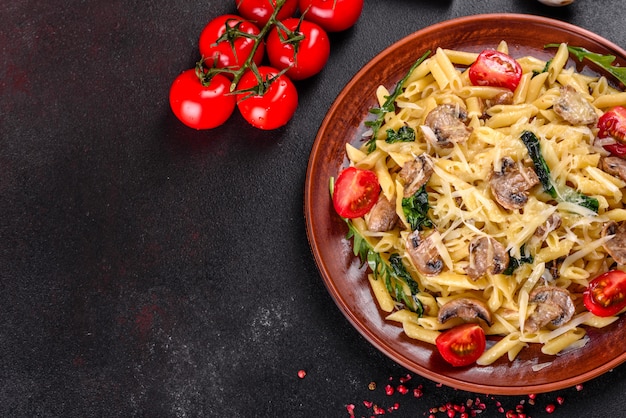 Pasta met champignons, kaas, spinazie, rukkola en kerstomaatjes. Italiaans gerecht, mediterrane cultuur