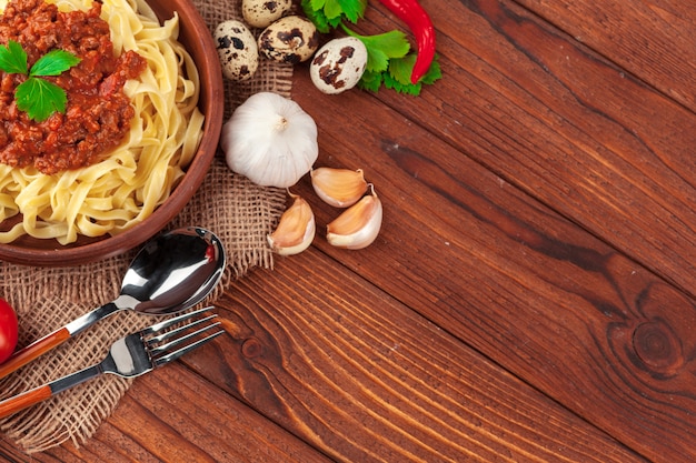 Pasta met vlees, tomatensaus en groenten op tafel