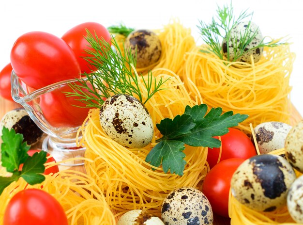 Pasta nests with cherry tomatoes and quail eggs