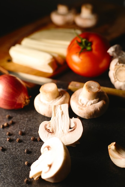 Pasta or pizza ingredients for cooking. top view. Italian food concept. Tomatoes, mushrooms, cheese, onion and spices. Copy space